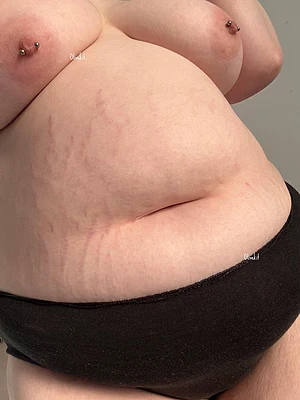 A striped tummy and pretty nipple piercings await you